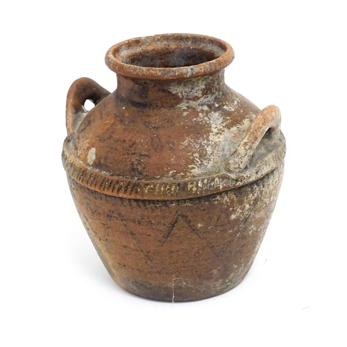 114A - A stoneware pot / vessel with twin handles and traces of geometric detail. Approx. 8