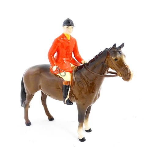 116 - A Beswick Huntsman on a brown horse, model no. 1501. Marked under. Approx. 8