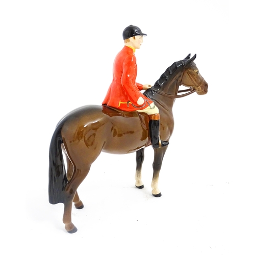 116 - A Beswick Huntsman on a brown horse, model no. 1501. Marked under. Approx. 8