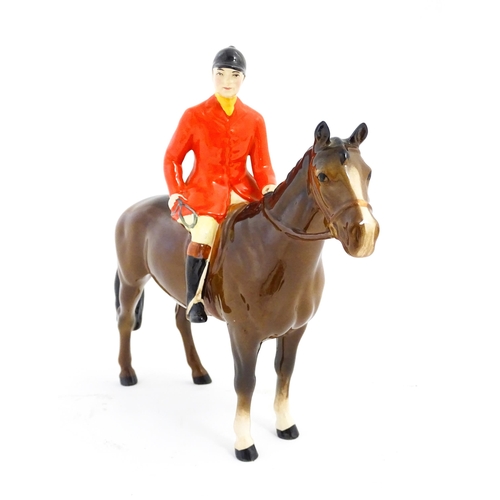 116 - A Beswick Huntsman on a brown horse, model no. 1501. Marked under. Approx. 8