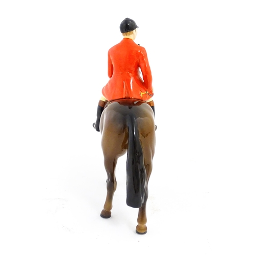 116 - A Beswick Huntsman on a brown horse, model no. 1501. Marked under. Approx. 8