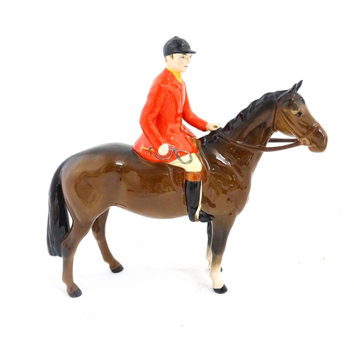 116 - A Beswick Huntsman on a brown horse, model no. 1501. Marked under. Approx. 8