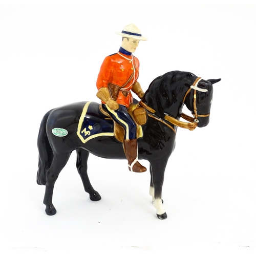 117 - A Beswick Canadian Mountie on a black horse, model no. 1375. Marked under. Approx. 8 1/4