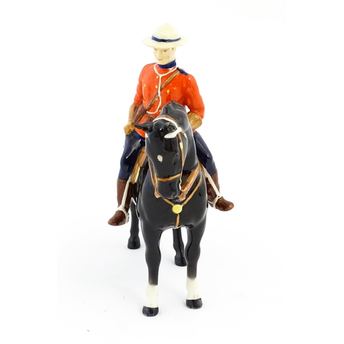 117 - A Beswick Canadian Mountie on a black horse, model no. 1375. Marked under. Approx. 8 1/4