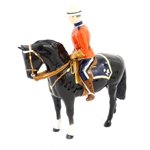 117 - A Beswick Canadian Mountie on a black horse, model no. 1375. Marked under. Approx. 8 1/4