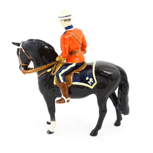 117 - A Beswick Canadian Mountie on a black horse, model no. 1375. Marked under. Approx. 8 1/4