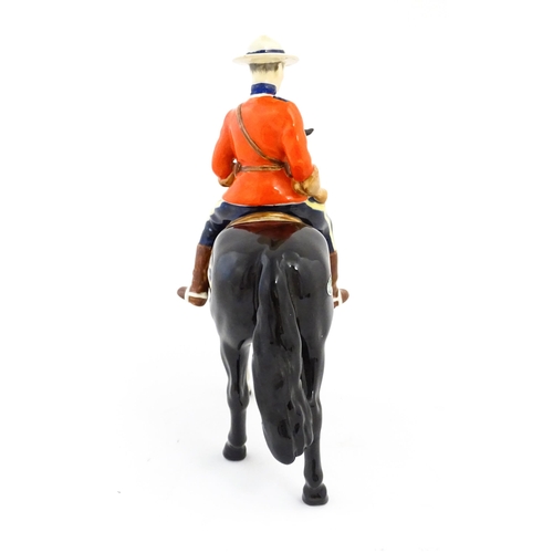 117 - A Beswick Canadian Mountie on a black horse, model no. 1375. Marked under. Approx. 8 1/4