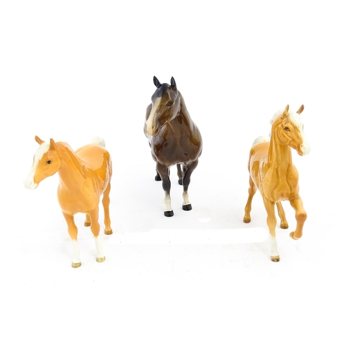 118 - Three Beswick models of horses comprising a palomino Prancing Arab model no. 1261, a palomino Arab h... 