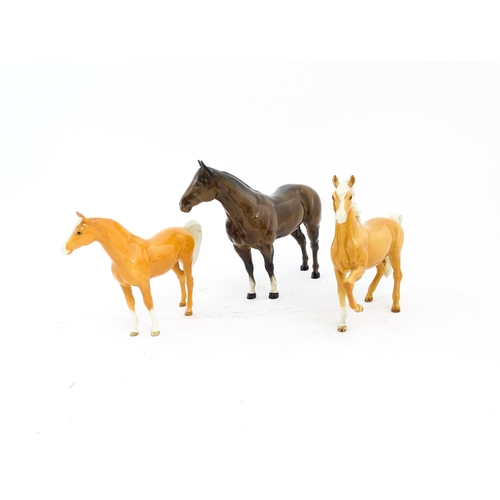 118 - Three Beswick models of horses comprising a palomino Prancing Arab model no. 1261, a palomino Arab h... 