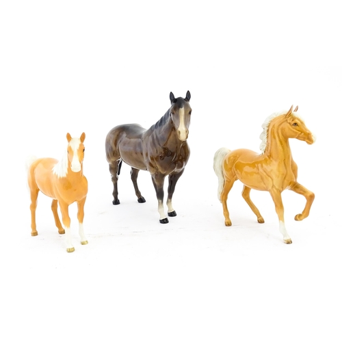 118 - Three Beswick models of horses comprising a palomino Prancing Arab model no. 1261, a palomino Arab h... 