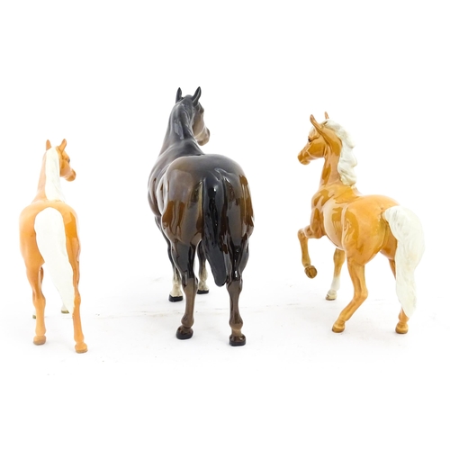 118 - Three Beswick models of horses comprising a palomino Prancing Arab model no. 1261, a palomino Arab h... 