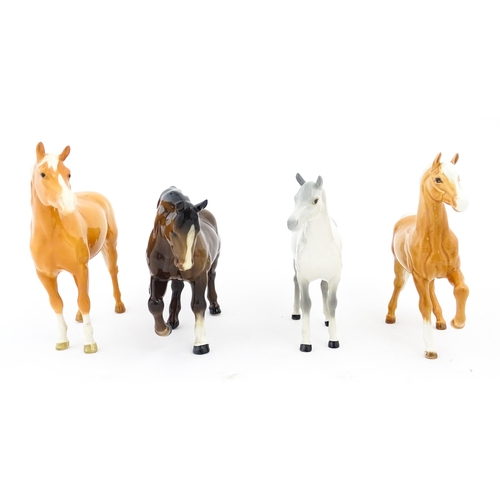 119 - Four Beswick models of horses comprising a palomino Prancing Arab model no. 1261, a brown horse with... 