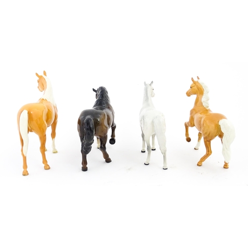 119 - Four Beswick models of horses comprising a palomino Prancing Arab model no. 1261, a brown horse with... 