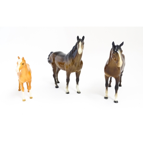 121 - Three Beswick models of horses comprising a brown horse with swish tail, no. 1182, a brown imperial,... 