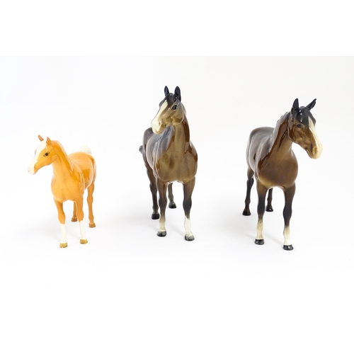 121 - Three Beswick models of horses comprising a brown horse with swish tail, no. 1182, a brown imperial,... 