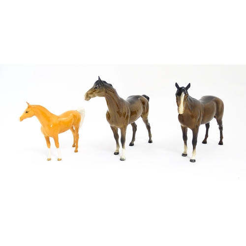 121 - Three Beswick models of horses comprising a brown horse with swish tail, no. 1182, a brown imperial,... 