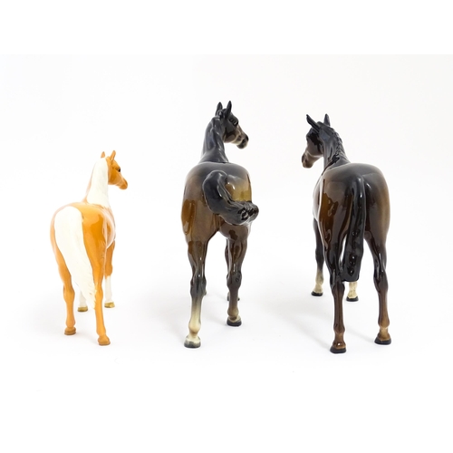 121 - Three Beswick models of horses comprising a brown horse with swish tail, no. 1182, a brown imperial,... 