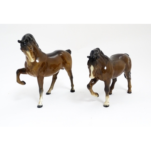 122 - Two Beswick models of horses to include a brown horse with head tucked and leg up, model no. 1549, a... 