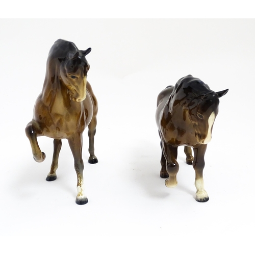 122 - Two Beswick models of horses to include a brown horse with head tucked and leg up, model no. 1549, a... 