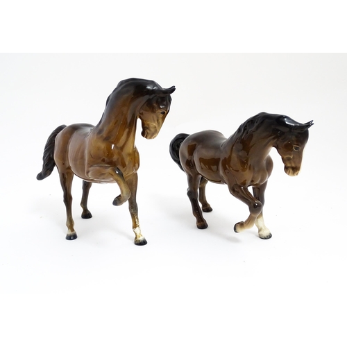 122 - Two Beswick models of horses to include a brown horse with head tucked and leg up, model no. 1549, a... 