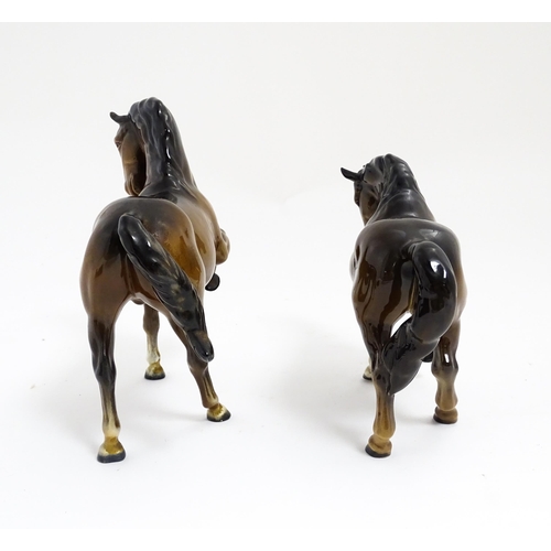 122 - Two Beswick models of horses to include a brown horse with head tucked and leg up, model no. 1549, a... 