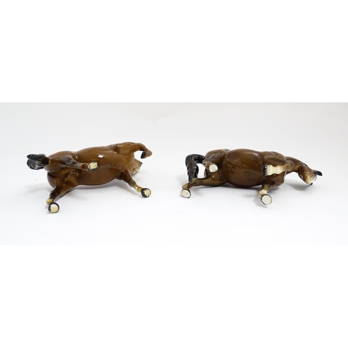 122 - Two Beswick models of horses to include a brown horse with head tucked and leg up, model no. 1549, a... 