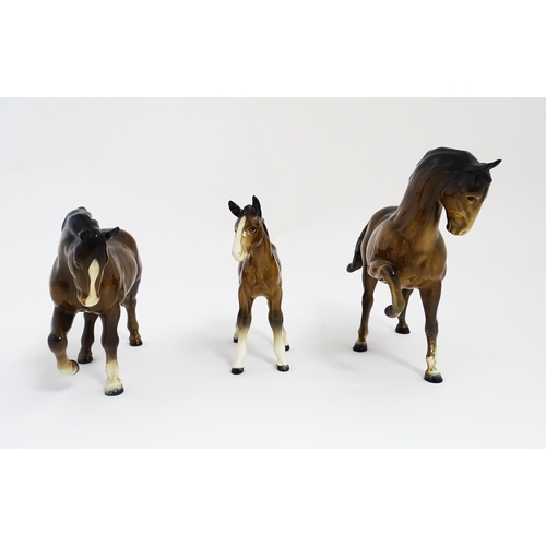 122 - Two Beswick models of horses to include a brown horse with head tucked and leg up, model no. 1549, a... 