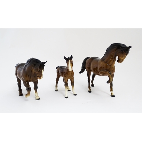 122 - Two Beswick models of horses to include a brown horse with head tucked and leg up, model no. 1549, a... 