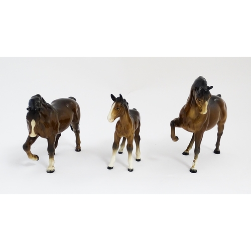 122 - Two Beswick models of horses to include a brown horse with head tucked and leg up, model no. 1549, a... 