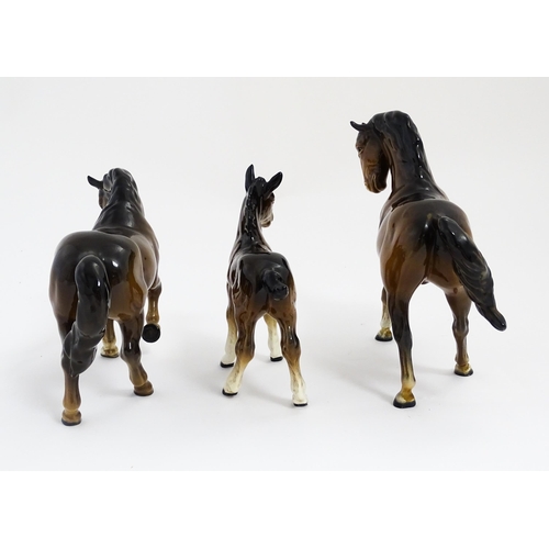 122 - Two Beswick models of horses to include a brown horse with head tucked and leg up, model no. 1549, a... 