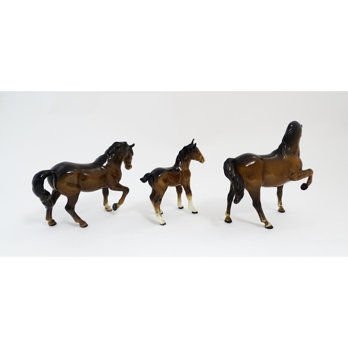 122 - Two Beswick models of horses to include a brown horse with head tucked and leg up, model no. 1549, a... 