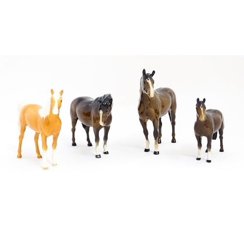 123 - Four Beswick models of horses comprising to include a brown mare, a palomino, and two brown horses. ... 