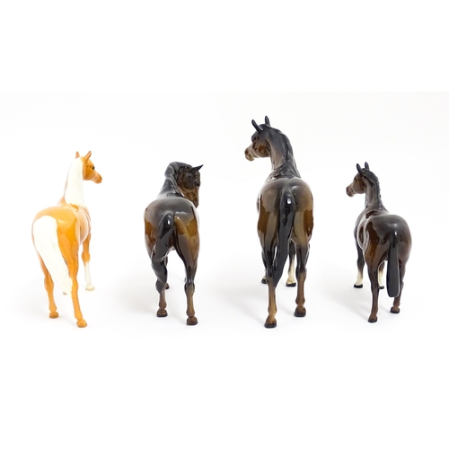 123 - Four Beswick models of horses comprising to include a brown mare, a palomino, and two brown horses. ... 