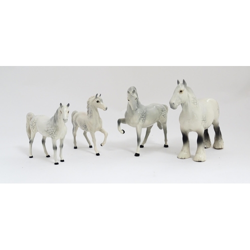 124 - Four Beswick models of horses in dapple grey to include a head tucked leg up no. 1549, shire mare no... 