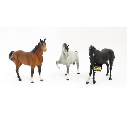 125 - Three Beswick matte models of horses to include Black Beauty no. 2466, a brown swish tail no. 1182 a... 