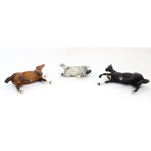 125 - Three Beswick matte models of horses to include Black Beauty no. 2466, a brown swish tail no. 1182 a... 