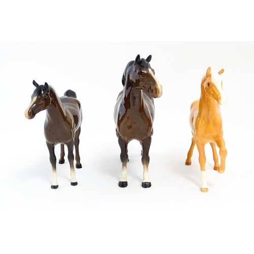 127 - Three Beswick models of horses to include a Prancing Arab palomino, a brown Arab horse, and another.... 