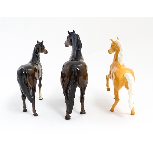 127 - Three Beswick models of horses to include a Prancing Arab palomino, a brown Arab horse, and another.... 