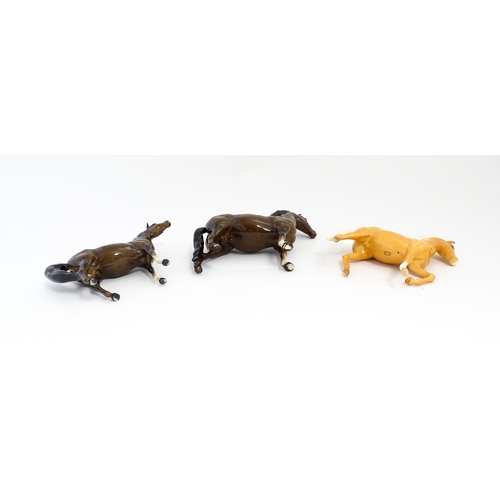 127 - Three Beswick models of horses to include a Prancing Arab palomino, a brown Arab horse, and another.... 