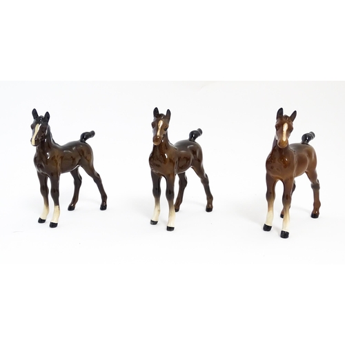 128 - A quantity of Beswick brown horses / foals model no. 763 etc. Together with two Beswick Arab head wa... 