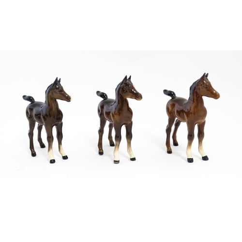 128 - A quantity of Beswick brown horses / foals model no. 763 etc. Together with two Beswick Arab head wa... 