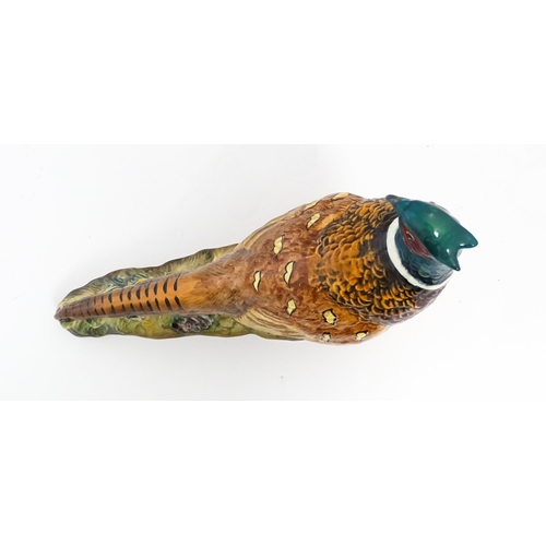 131 - A Beswick model of a pheasant, model no. 1225. Marked under. Approx. 9 3/4