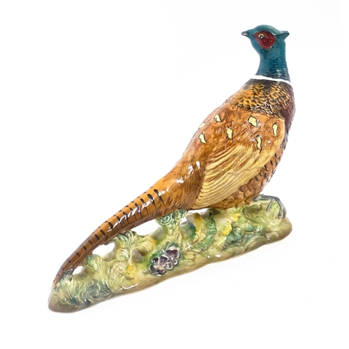 131 - A Beswick model of a pheasant, model no. 1225. Marked under. Approx. 9 3/4