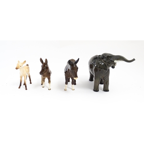 133 - Four Beswick models of animals comprising elephant model no. 974, a fawn no. 1000B, a donkey no. 136... 