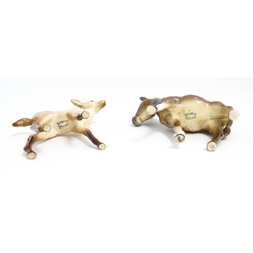 133 - Four Beswick models of animals comprising elephant model no. 974, a fawn no. 1000B, a donkey no. 136... 