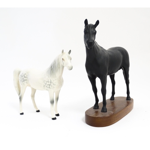 139 - Two Royal Doulton models of horses comprising Black Beauty and a dapple grey horse. Largest approx. ... 