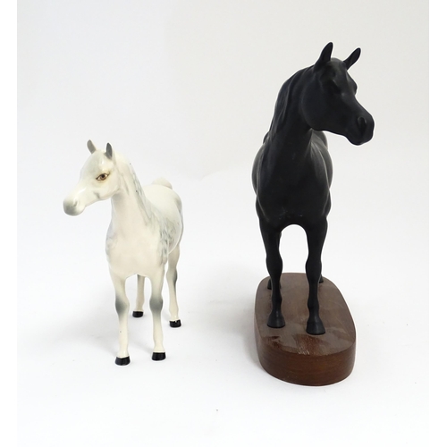 139 - Two Royal Doulton models of horses comprising Black Beauty and a dapple grey horse. Largest approx. ... 