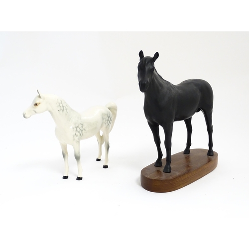 139 - Two Royal Doulton models of horses comprising Black Beauty and a dapple grey horse. Largest approx. ... 