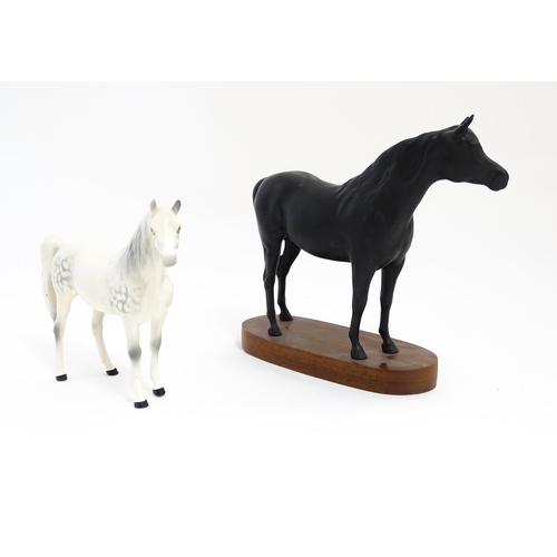 139 - Two Royal Doulton models of horses comprising Black Beauty and a dapple grey horse. Largest approx. ... 