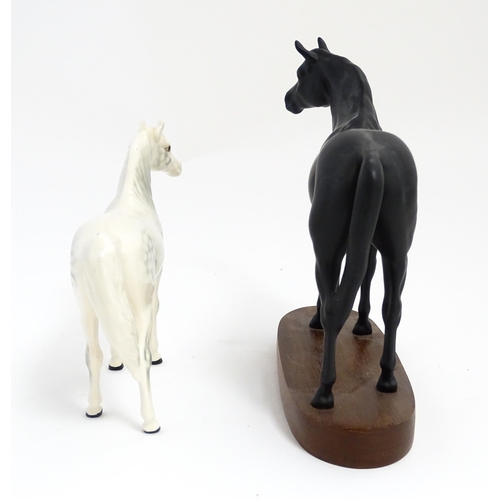 139 - Two Royal Doulton models of horses comprising Black Beauty and a dapple grey horse. Largest approx. ... 